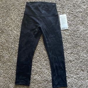 Size 4 lululemon Wunder Train HR Crop 21” leggings, black camo print